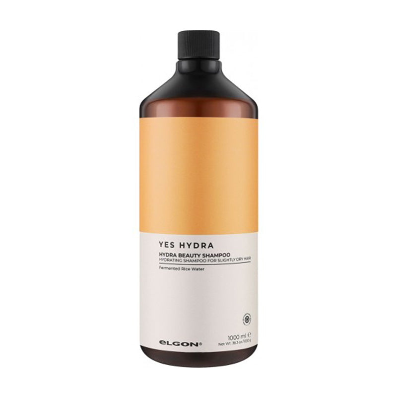 Shampoo per capelli secchi in flacone ambra con etichetta bianca e arancione. Tappo a vite nero.