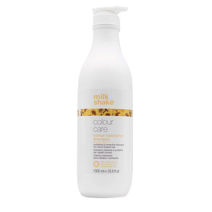 Bottiglia di shampoo da litro bianca con tappo a pressione. Piccola immagine con richiamo al fiore di girasole sulla facciata principale.